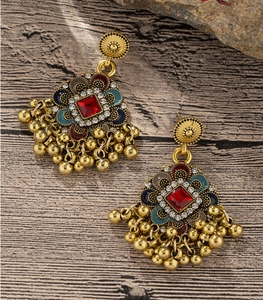 Detailed close-up of retro ethnic flower earrings with enamel and sparkling rhinestones
