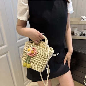 Handmade hollow straw crossbody bag with crochet flower and drawstring lining