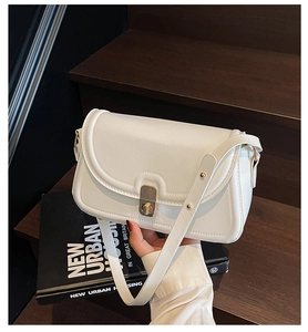 Vue détaillée du sac bandoulière blanc en similicuir avec fermoir rotatif doré