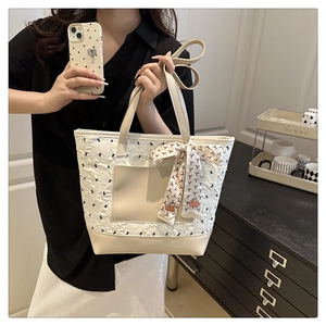 Detailed lace texture and scarf decoration on the cream white shoulder tote bag