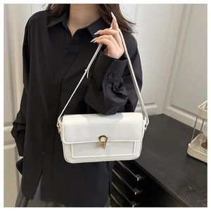 Detailed view of white litchi pattern leather shoulder bag with golden horsebit buckle