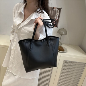 Classic black leather tote bag with reinforced handles for stylish women commuting