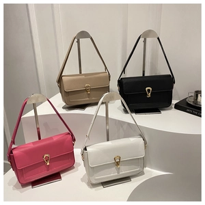 Detail view of four textured crossbody bags in beige, black, pink, and white with metal buckles
