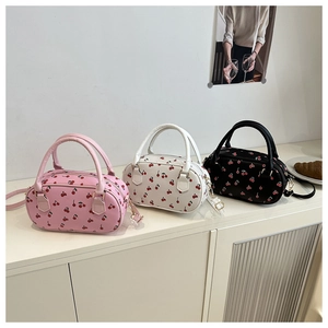 Three stylish Boston pillow bags with cherry print in pink, white and black colors