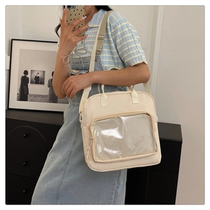 Detail of cream canvas messenger bag with a transparent mesh window for DIY customization