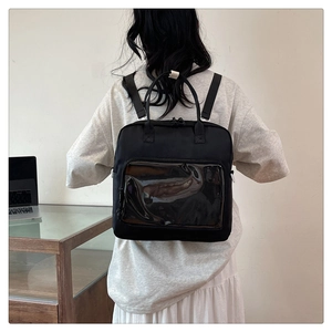 Detail of black ita bag with transparent PVC window for display and adjustable straps