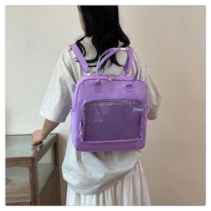 Detail of purple nylon multi-functional backpack with clear mesh pocket and top handles