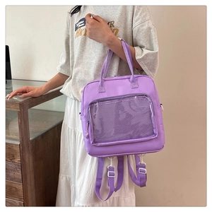 Detail of lavender purple canvas messenger bag featuring a transparent mesh front pocket