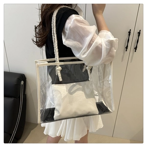 Detail of transparent PVC tote bag with white cotton rope handles on a shoulder model