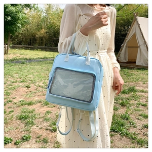 Detail of light blue ita bag showing the clear PVC window for displaying pins on the grass