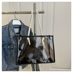 Détail du sac cabas en PVC transparent avec poignées en coton et bordure noire chic
