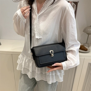 Classic black litchi pattern leather crossbody bag with a unique gold metal buckle