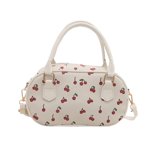Fashionable cherry print Boston barrel bag with detachable shoulder strap in cream PU leather