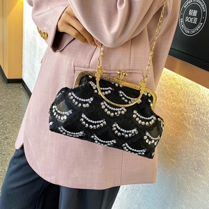 Retro black sequin handbag with gold metal handle and chain strap for elegant styling