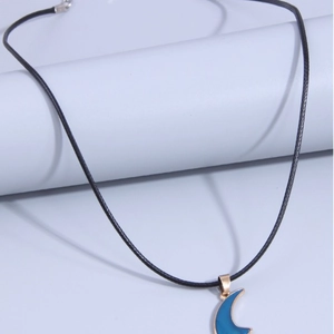 Minimalist moon pendant necklace with dark blue crescent design and black cord