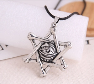 Macro shot of silver bone hexagram necklace pendant with all-seeing eye and black cord