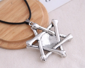 Close-up of retro hexagram pendant featuring six-bone alloy design on a rustic wood base