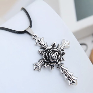 Vintage silver rose cross pendant necklace on a black woven cord with intricate details