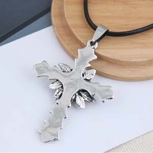 Vintage silver cross necklace with leaf detailing on a black cord for unisex styling
