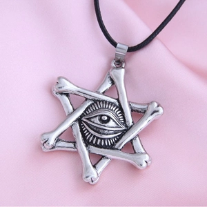 Gothic pentagram bone pendant necklace with All-Seeing Eye symbol on pink satin base