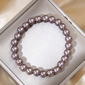 Detail of 8mm grey pearl bracelet with metallic luster in a square jewelry box