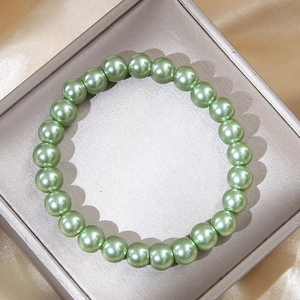 Pale green 0.8cm pearl bracelet displayed in an elegant jewelry box with satin lining