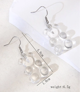 Detail view of white gummy bear earrings with hook design and dimensions 4.8x1.8cm