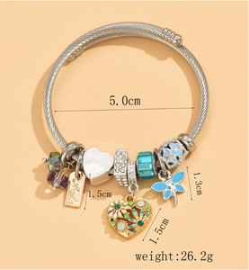Detail view of a dragonfly heart charm bangle with dimensions and weight info.