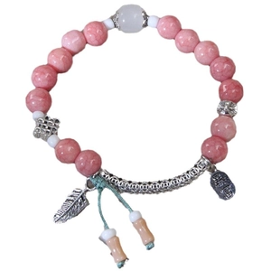Handmade pink beaded bracelet with silver feather pendant and ethnic woven cord