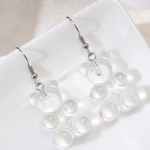 Chic transparent gummy bear drop earrings with silver hooks on a white ceramic plate