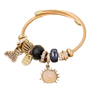 Elegant gold woven steel bracelet with bear, sunflower, and Made with Love charms