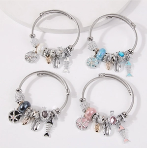 Detail of four ocean-themed bracelets with starfish pendants and colorful glass beads