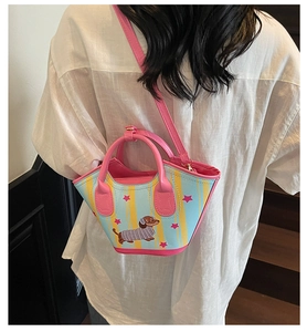 Detail of dachshund bucket bag featuring pink stars and striped pattern on blue leather