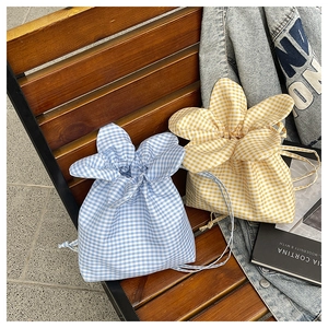 Detail of blue and yellow gingham drawstring bucket bags with cute bunny ear handles