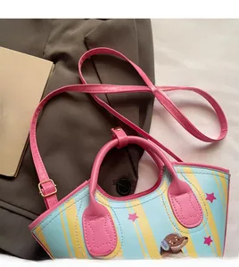 Close-up of adjustable pink shoulder strap and cartoon dog print bucket bag
