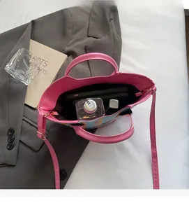 Top view of pink leather bucket bag interior showing spacious capacity for daily essentials