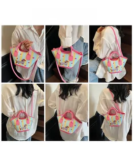 Blue dog pattern bucket bag shown in hand-held, shoulder, and crossbody styles