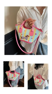Detail of dachshund print bucket bag with yellow stripes and pink leather straps