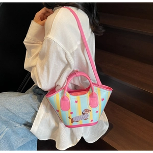 Detail of colorful dachshund bucket bag with pink handles and cartoon puppy print
