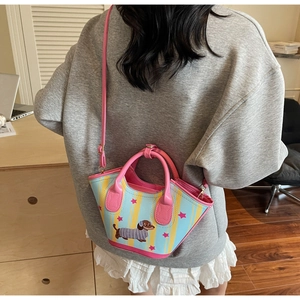 Back view of model wearing a mini bucket bag with blue stripes and cartoon dachshund print