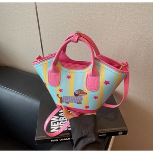 Detail of dachshund print bucket bag with blue and yellow stripes and pink leather trim