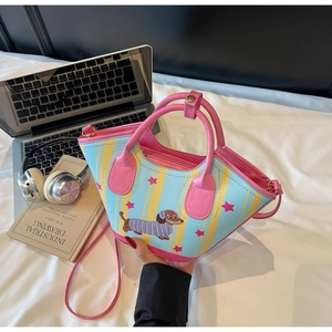 Detail of dachshund print bucket bag with yellow and blue stripes and pink strap