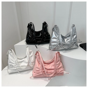 Gruppenfoto gefalteter Hobo-Taschen in Schwarz, Silber, Weiß und Rosa mit Schleifen