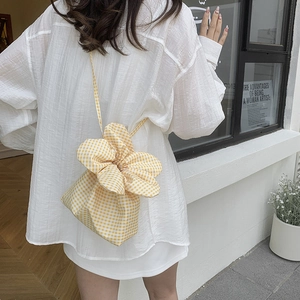 Yellow plaid canvas drawstring bucket bag with floral-inspired pleated top design