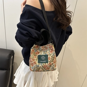 Retro floral canvas tote bag with dual straps and green woven label for daily commute