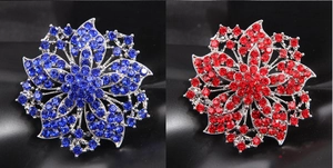 Detailed comparison of sparkling blue and red crystal flower brooches in silver setting