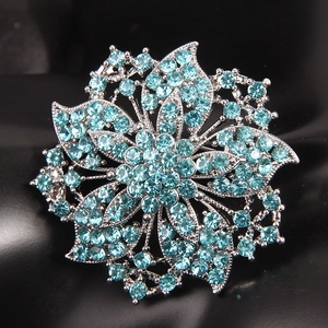 Elegant silver-tone flower brooch with sparkling light blue rhinestones in floral shape
