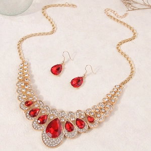 Elegant gold-plated jewelry set featuring red teardrop gemstones and white rhinestones