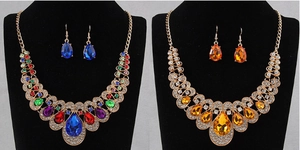 Ethnic style jewelry sets with colorful gemstones and rhinestones on velvet stands