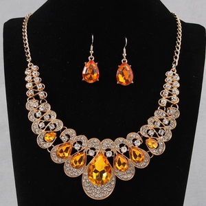 Detail of bib necklace and drop earrings with orange water-drop gemstones and gold alloy